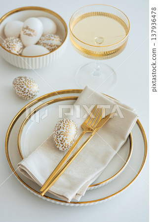 Elegant Easter Table Setting with Decorative Egg and Spring Details Elegant Easter Table Setting with Decorative Egg and Spring Details 137936478