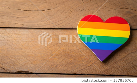 Colorful Rainbow Heart Symbol on Rustic Wood Background 137936703