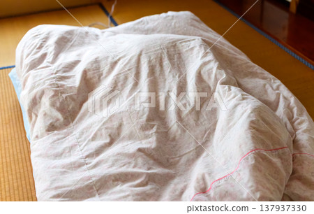 A comforter spread out on the tatami mat A comforter spread out on the tatami mat 137937330