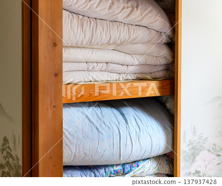 Futons and comforters piled up in a Japanese-style closet. Futons and comforters piled up in a Japanese-style closet. 137937428