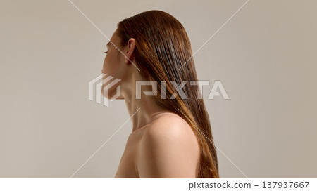 Woman with long hair after treatment on neutral background. Woman with long hair after treatment on neutral background. 137937667