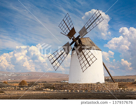 Traditional windmill standing in arid lanzarote landscape on canary islands Traditional windmill standing in arid lanzarote landscape on canary islands 137937676