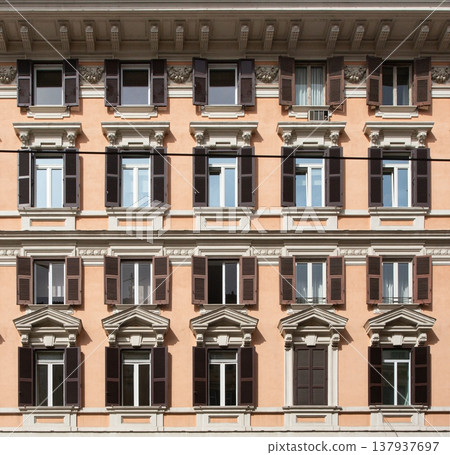 Residential building facade with many windows and shutters 137937697