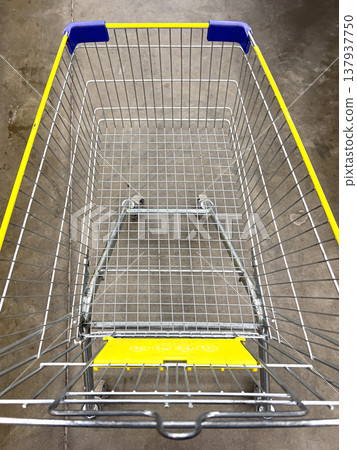 Empty shopping cart on concrete floor ready for groceries Empty shopping cart on concrete floor ready for groceries 137937750