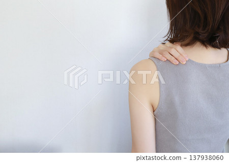 Back view of a woman suffering from stiff shoulders 137938060