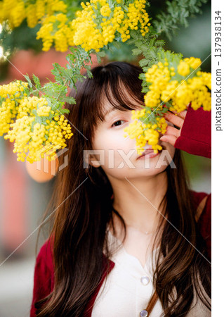 Mimosa and young woman 137938134