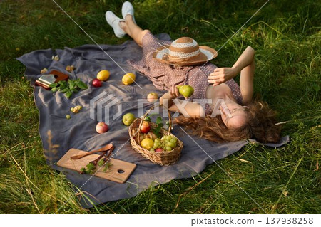 Chill female social media star relaxing outdoors in sunshine 137938258