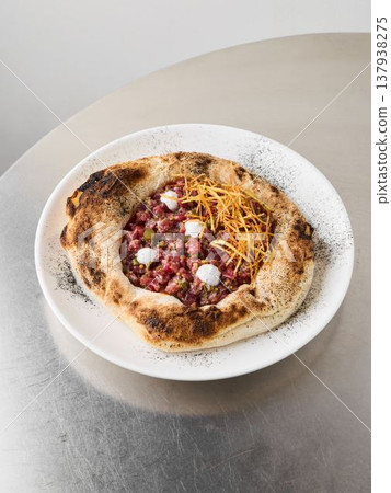 Creamy cheese and herb crumble enhance beetroot pizza presentation 137938275