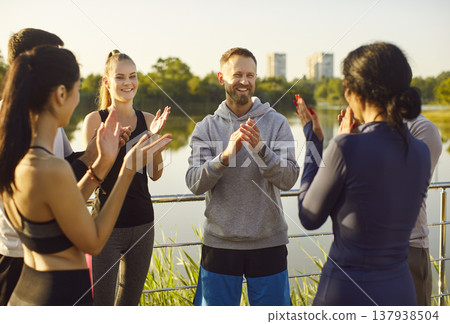 Sporty group celebrating win, happy fit active friends applauding, people after running together  137938504