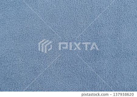 Close-up of soft navy blue fleece fabric with gentle waves. The thick, plush texture creates natural highlights and shadows, offering a cozy and warm textile background Close-up of soft navy blue fleece fabric with gentle waves. The thick, plush texture creates natural highlights and shadows, offering a cozy and warm textile background 137938620
