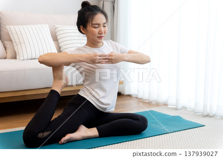 young woman stretching in a yoga pose for relaxation and self young woman stretching in a yoga pose for relaxation and self 137939027