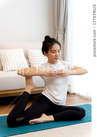 young woman stretching in a yoga pose for relaxation and self young woman stretching in a yoga pose for relaxation and self 137939028