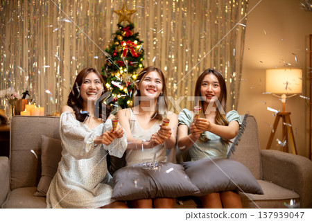 three young woman sitting in party pulling paper Shoot for fun three young woman sitting in party pulling paper Shoot for fun 137939047