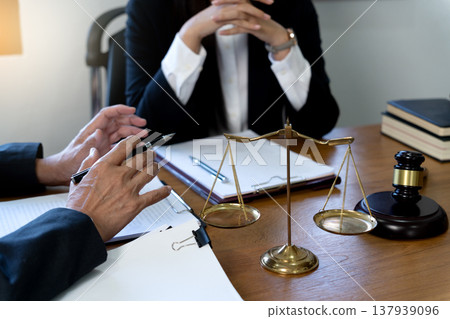 Lawyers talking to a team of women in Law firm Lawyers talking to a team of women in Law firm 137939096
