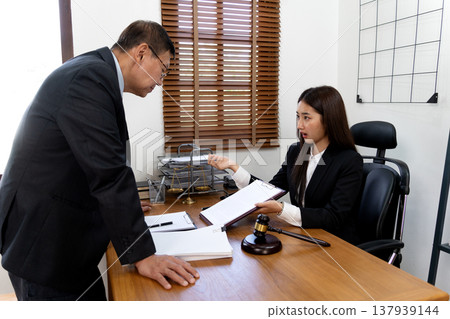 The boss or client is listening intently as the lawyer The boss or client is listening intently as the lawyer 137939144
