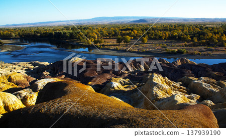 A view of the Yardang formations of the Five-Colored Beach in Xinjiang and the Ir-Tish River. A view of the Yardang formations of the Five-Colored Beach in Xinjiang and the Ir-Tish River. 137939190