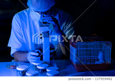 The scientist biologist is working very seriously use microscope The scientist biologist is working very seriously use microscope 137939462