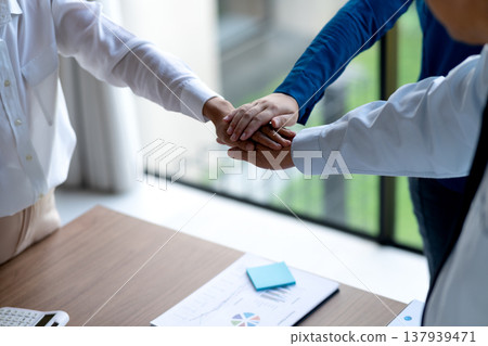 group of businesspeople Show the symbol by stacking hands 137939471