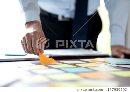 manager and businesswoman Picking ideas on a sticky note 137939592