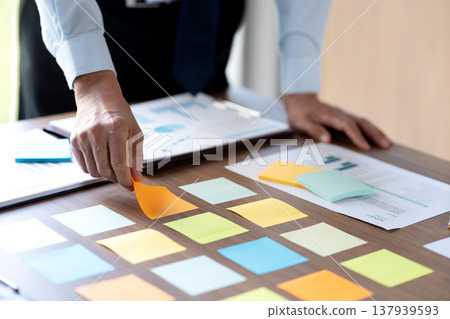 manager and businesswoman Picking ideas on a sticky note 137939593
