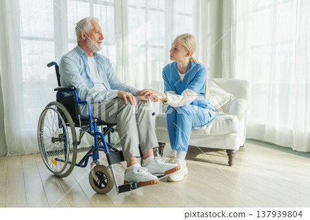 Help support retirement healthcare. Nurse helping old man in wheelchair. Patient and woman in nursing home for medical caregiver. Nurse taking care of paralyzed man in chair for people with disability 137939804