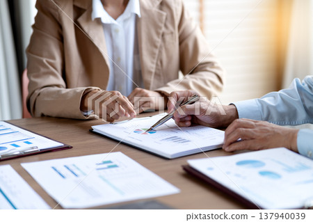 businesswoman is pointing to marketing and management datasheets  team  brainstorm 137940039