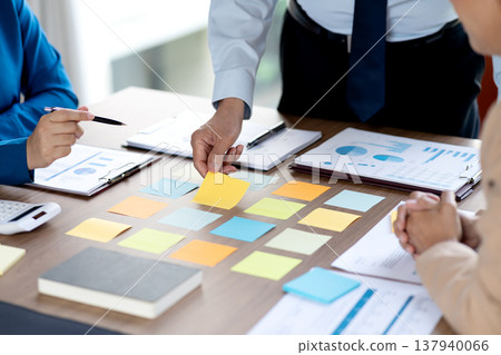The marketing team is gathering information and writing down The marketing team is gathering information and writing down 137940066