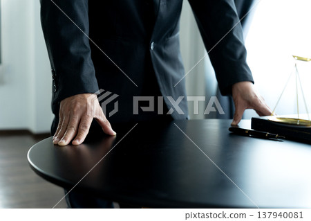 Lawyer standing putting both hands on the table Lawyer standing putting both hands on the table 137940081