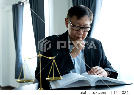 lawyer sitting alone working Reading legal documents for legal 137940243