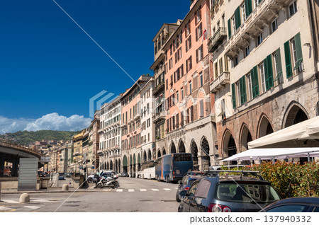 Genoa, liguria, italy. May 18,2024. Genoa city street view with historic colorful buildings featuring arches along sottoripa, experiencing daily urban life 137940332