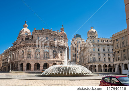 Genoa, liguria, italy. May 18,2024. Piazza de ferrari, genoa's main square, featuring an iconic fountain with historic palace buildings under a clear blue sky 137940336