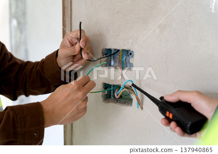Construction supervisors are inspecting the progress of electrical Construction supervisors are inspecting the progress of electrical 137940865
