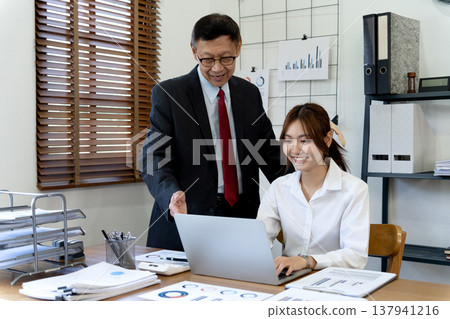 The senior boss is explaining to the assistant or secretary The senior boss is explaining to the assistant or secretary 137941216