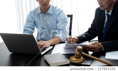 Lawyers and assistants are helping each other down legal documents 137941329