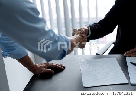 Legal counsel lawyer and client shaking hands to congratulate Legal counsel lawyer and client shaking hands to congratulate 137941331