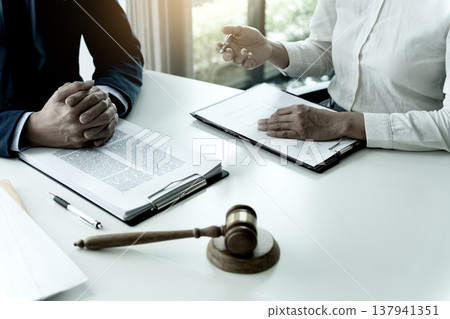 lawyer sitting and listening to a client tell a story who wants to help lawyer sitting and listening to a client tell a story who wants to help 137941351