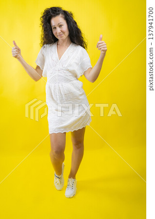 Woman smiling giving double thumbs up gesture 137941700