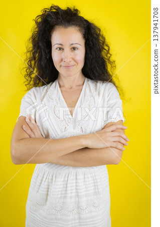 Confident woman with arms crossed expressing determination Confident woman with arms crossed expressing determination 137941708