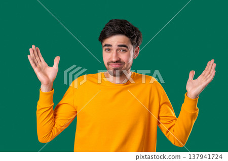 Young Man Shrugs Shoulders Showing Uncertainty, Confusion, Dilemma, Hesitation 137941724