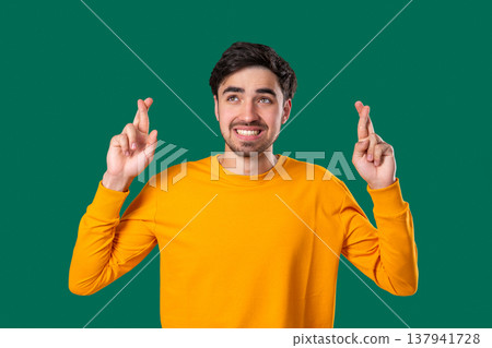 Handsome Man Crossing Fingers. Praying With Hopeful Expression, Silently Prays Handsome Man Crossing Fingers. Praying With Hopeful Expression, Silently Prays 137941728