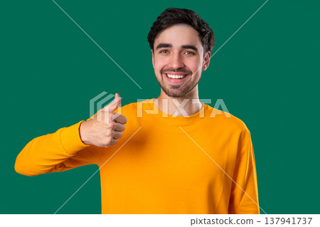 Handsome Man With Hand Sign Like, Thumbs Up Gesture.happy Guy On green Studio Handsome Man With Hand Sign Like, Thumbs Up Gesture.happy Guy On green Studio 137941737