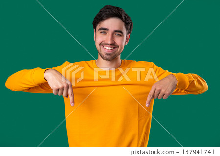 Young Man Points Both Index Fingers Downward To Indicate Area Below Young Man Points Both Index Fingers Downward To Indicate Area Below 137941741