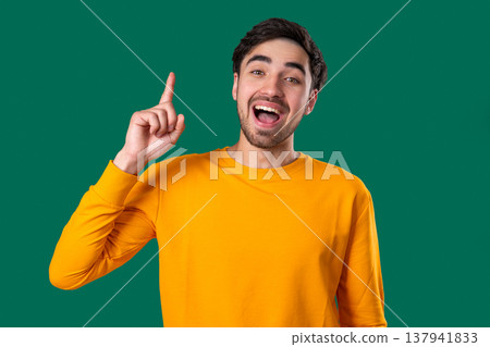 Genius Idea. Resourceful 20S Aged Man Has Eureka Moment, Pointing Finger Up, Remember What He forgot. Memory concept. Genius Idea. Resourceful 20S Aged Man Has Eureka Moment, Pointing Finger Up, Remember What He forgot. Memory concept. 137941833