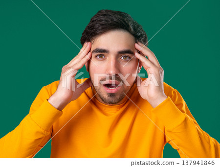 Young Sick Man With Headache,Touching Temples,Suffering. Guy Puts Hand On Head Young Sick Man With Headache,Touching Temples,Suffering. Guy Puts Hand On Head 137941846