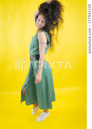Happy woman with curly hair smiling looking back Happy woman with curly hair smiling looking back 137942109