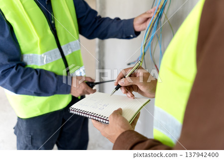 Foreman and supervisor are pointing out corrections and installation 137942400