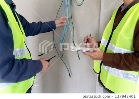 Foreman and supervisor are pointing out corrections and installation 137942401