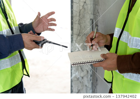 Foreman and supervisor are pointing Plastering work 137942402