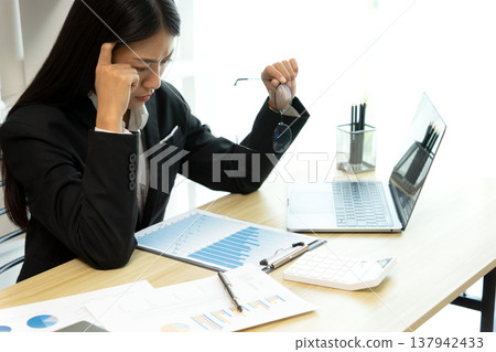 young business woman Seriously thinking while looking at company young business woman Seriously thinking while looking at company 137942433