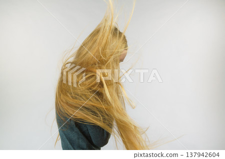 Girl hiding face with hair Girl hiding face with hair 137942604